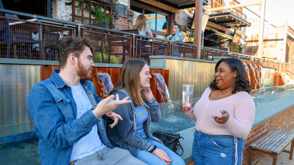 Students enjoying downtown including dining spots, shops.