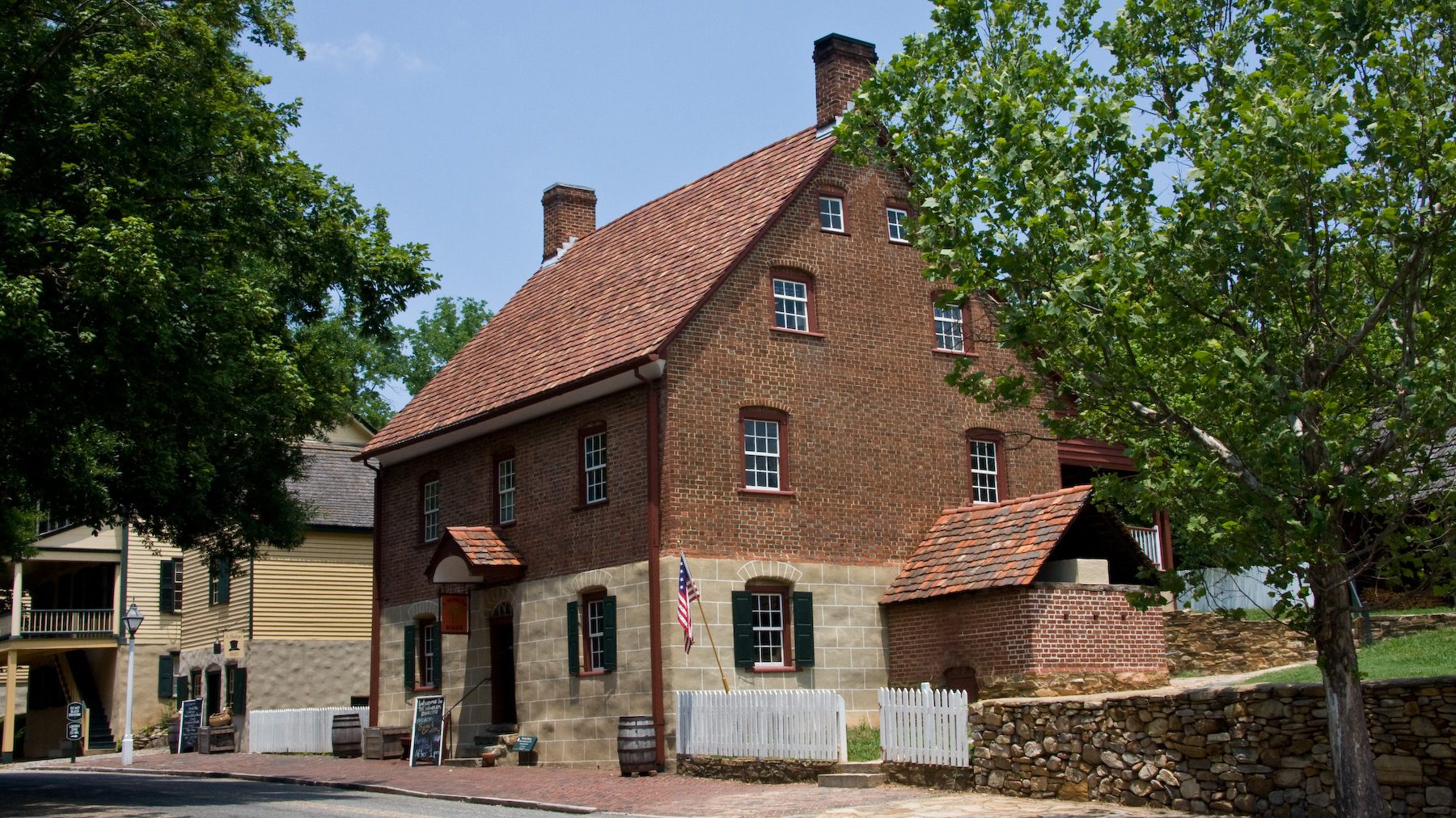 2-story, brick and stone 18th century cottage with red slate roof